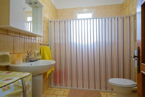 a bathroom with a shower with a sink and a toilet at Villetta del Salento 1 in Racale