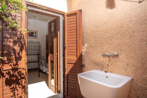 a bathroom with a sink next to a door at Vecchio Marino H4 in Palau