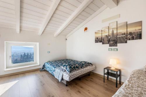 a bedroom with a bed and a window at La Casa In Collina Con Vista in Grezzana