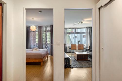 a bedroom with a bed and a living room at 2 Zimmer Appartement mit Pool in Schluchsee