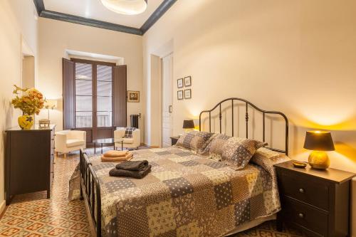 a bedroom with a bed and a living room at Casa Palma 12 in Vilafranca del Penedès