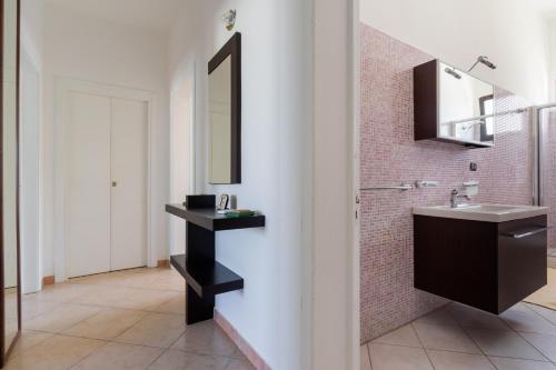 a bathroom with a sink and a mirror at Villa Tina a Torre Lapillo in Torre Lapillo