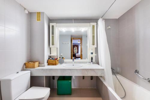 a bathroom with a sink and a toilet and a mirror at Ca Na Bel in Port de Soller