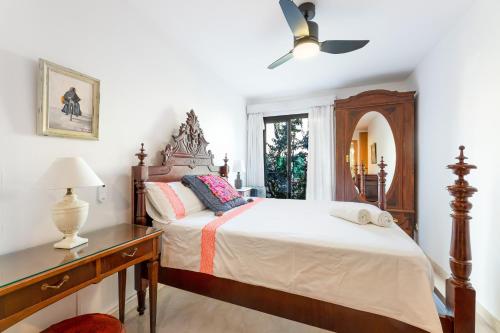 a bedroom with a bed and a dresser and a window at Ca Na Bel in Port de Soller