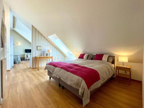a bedroom with a large bed in a attic at Ferienwohnung Fernblick in Königsberg in Bayern