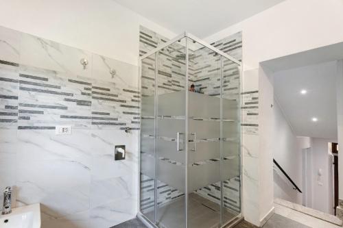 a glass shower in a bathroom with white walls at Al Vecchio Pozzo in Brebbia