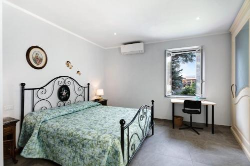 a bedroom with a bed and a window and a desk at Al Vecchio Pozzo in Brebbia