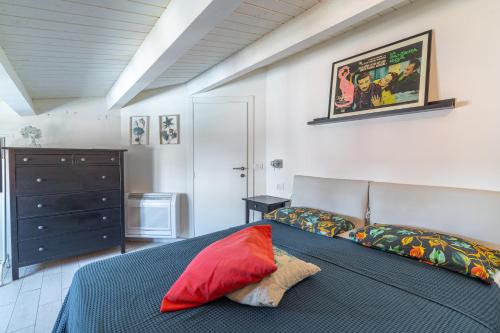 a bedroom with a bed with a red pillow on it at Elvi Suite Vista Mare Marzamemi in Marzamemi