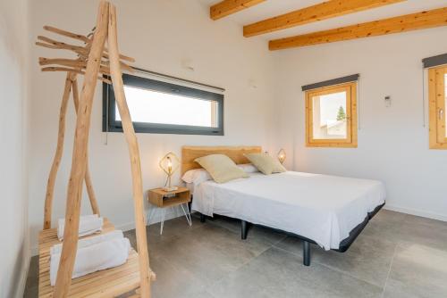 a bedroom with a large bed and a window at Cas Suis 7 in Campanet