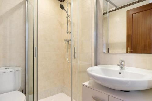 a bathroom with a shower and a sink and a toilet at Casa Noria in Vejer de la Frontera