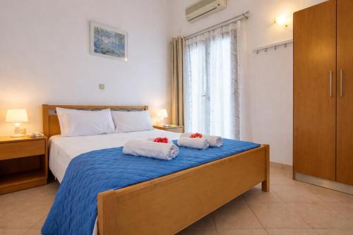 a bedroom with a bed with two towels on it at 32sq Apartment with Balcony in Vlachopoulátika
