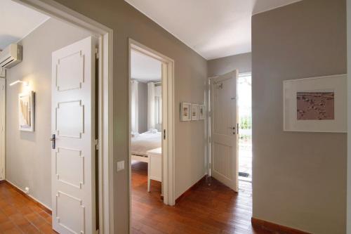 a hallway with a door and a bedroom with a bed at Villa Apfel in Vale do Lobo