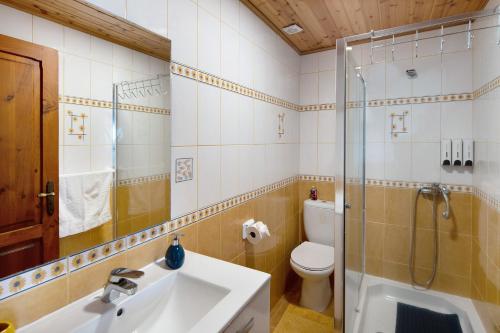 a bathroom with a sink and a shower and a toilet at Casa Do Monte in Achadinha