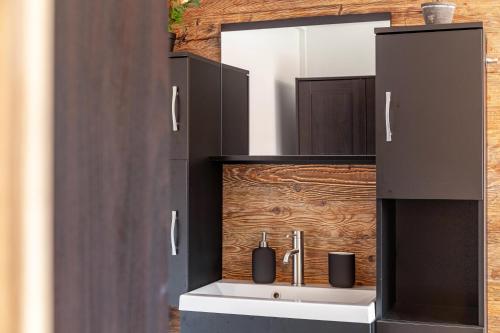 a bathroom with a sink and a mirror at Feichtenhäusl app 2 in Westendorf
