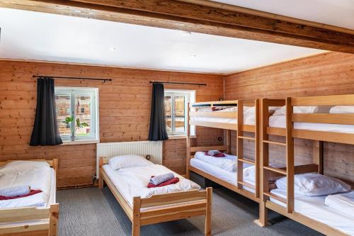 a room with three bunk beds in a cabin at Feichtenhäusl app 2 in Westendorf
