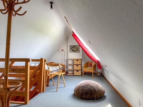 a room with a attic with a bed and a room with a room at Relas Ferienwohnungen - Spatzennest in Nordstrand