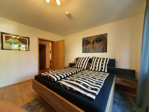 a bedroom with a bed with striped pillows on it at Stadler in Langenargen