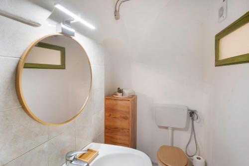 a bathroom with a sink and a mirror at Casetta l'Ulivo in Poggi