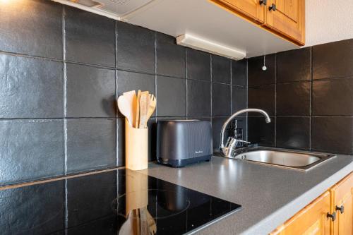 a kitchen with a sink and a counter top at Appartement Atlas in Albiez-Montrond
