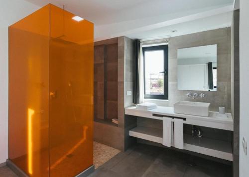 a bathroom with a shower and a sink and a mirror at Casa Agua Nueva 53 in Frontera