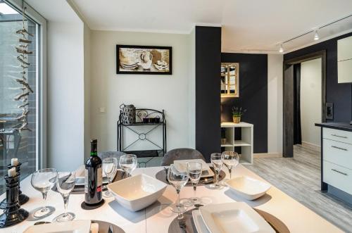 a dining room with a table with wine glasses on it at Femeer 01 in Wilhelmshaven