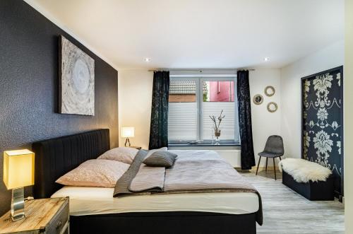 a bedroom with a large bed and a window at Femeer 01 in Wilhelmshaven