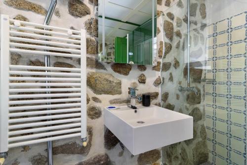 a bathroom with a white sink and a mirror at Quinta Santa Marinha in Arcos de Valdevez