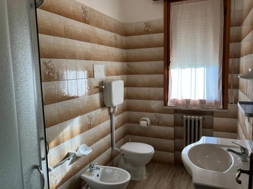 a bathroom with a toilet and a sink at Luna Apartment in Rimini