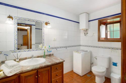 a bathroom with a sink and a toilet and a mirror at Casa Rural Arecida in Tijarafe