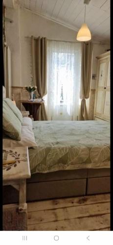 a bedroom with a large bed and a window at The Cottage by the lake 1 in San Maurizio dʼOpaglio