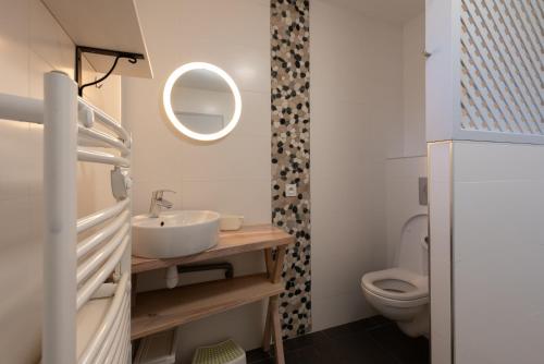 a bathroom with a sink and a toilet at Le Chalet des Retrouvailles in Sers