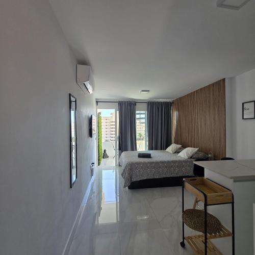 a bedroom with a bed and a desk in it at BlumLuxury Apartment in San Bartolomé