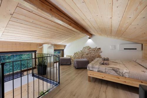 a room with a bed and a balcony at Lo Sarvanot in Bernezzo