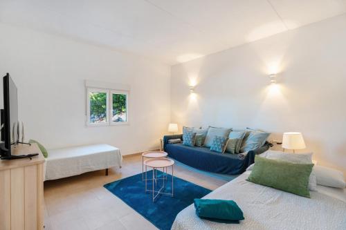 a living room with a blue couch and a table at La Casa del Caballo in Adeje