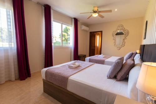 a bedroom with two beds and a window at Paulina in Jávea