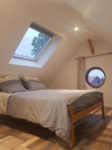 a bedroom with a bed and a window at Le Ty Gîte - Sud Morbihan in Théhillac
