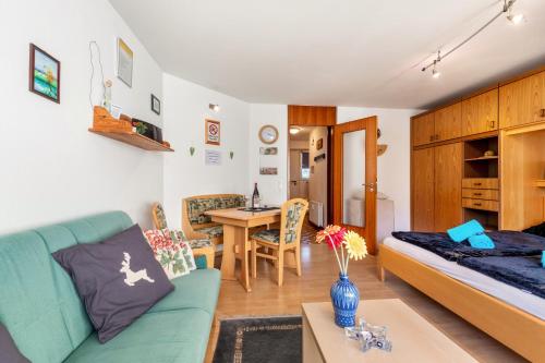 a living room with a blue couch and a table at Studti 134 in Beuren
