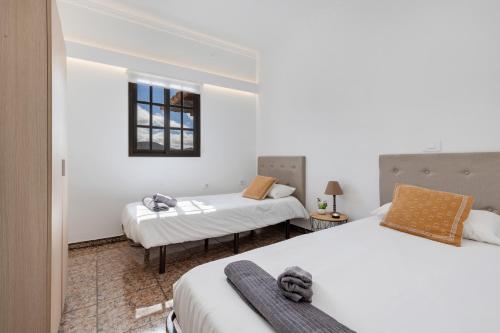 a room with two beds and a window at Villa Antonia in Betancuría
