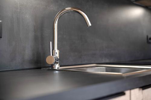 a stainless steel kitchen sink with a faucet at Haus Mader 1 in Riscone