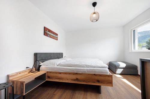 a bedroom with a bed and a desk and a window at Haus Mader 1 in Riscone