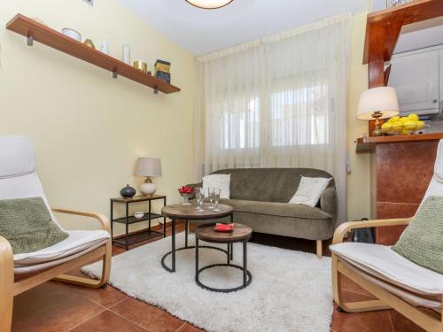 a living room with a couch and a table at Apartment Coco Golf by Interhome in Sant Jordi