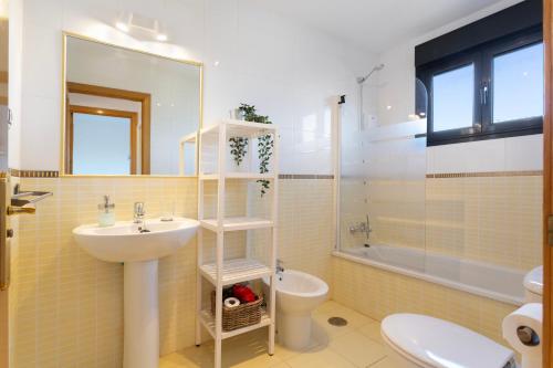 a bathroom with a sink and a toilet and a mirror at Sweet Home Majanicho in Majanicho