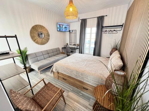 a living room with a bed and a couch at aeolian blu 3 in Parikia