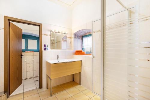 a bathroom with a sink and a shower at Gemütliches Apartment In Lohmen in Lohmen