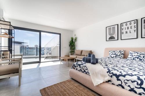 a bedroom with a bed and a living room at Ptm Arade View Penthouse T3 Duplex in Portimão