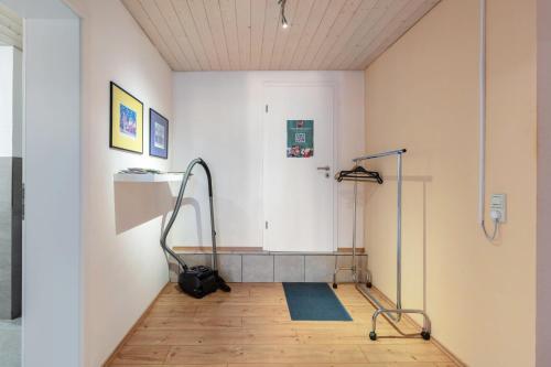 a room with a hose on the floor and a white wall at Connerhof Todtnauberg in Todtnau