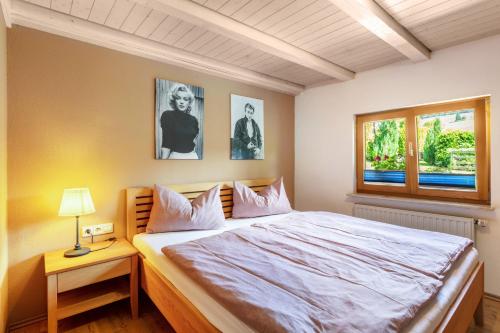 a bedroom with a large bed and a window at Connerhof Todtnauberg in Todtnau
