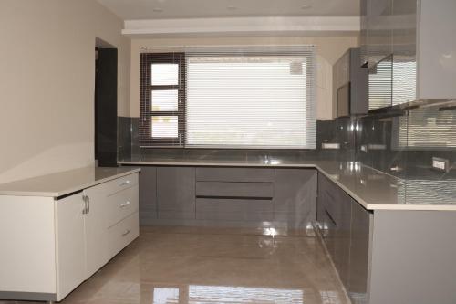 a kitchen with a stainless steel counter top at Ginger Garlic Chandigarh in Sohāna