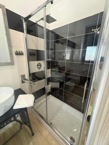 a shower with a glass door in a bathroom at Casa Concordia in Agrigento
