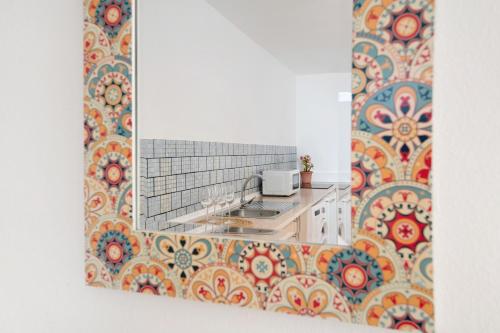 a kitchen with a sink and a patterned wall at Casa Rosi in Tinajo